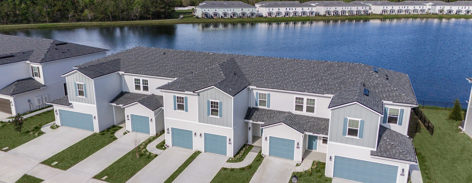 a row of houses next to a body of water