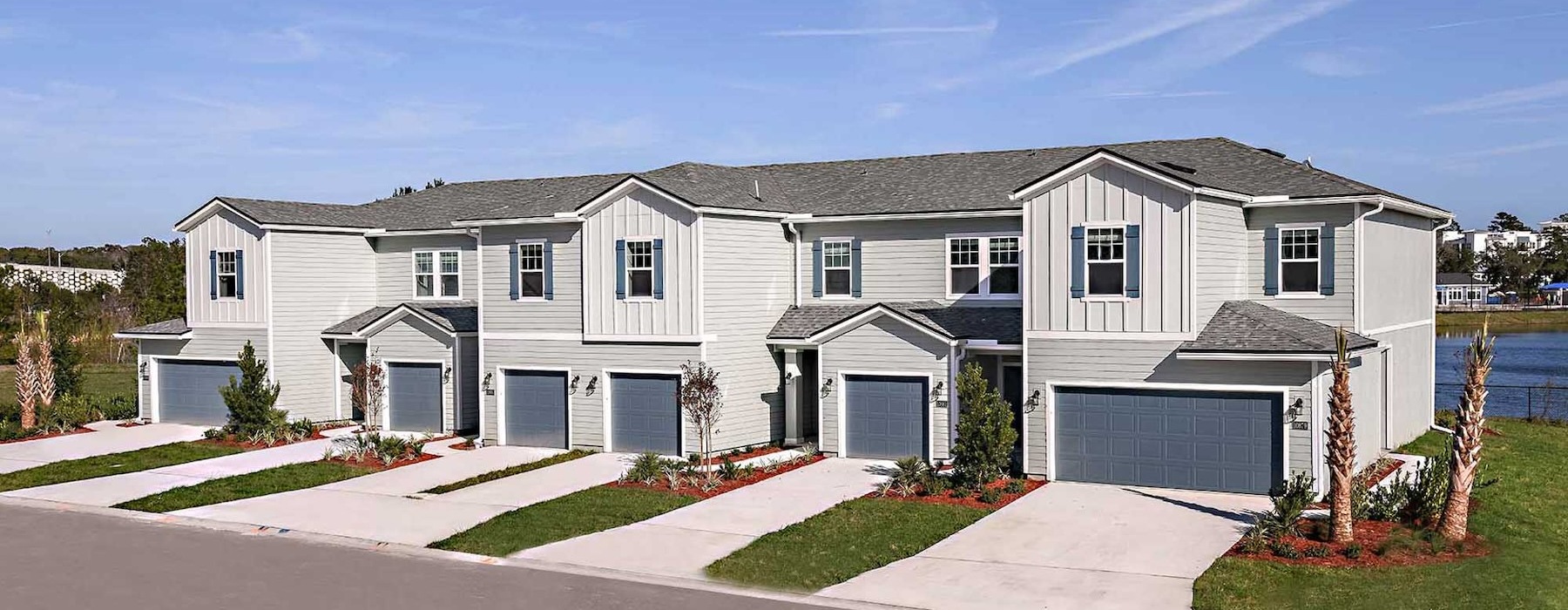 a row of houses with driveways