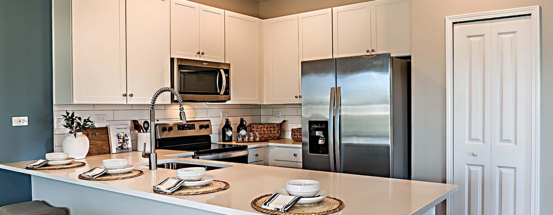 a kitchen with a large island fridge sink and barstools