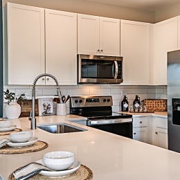 kitchen with ample counter-space, modern appliances and bright lighting