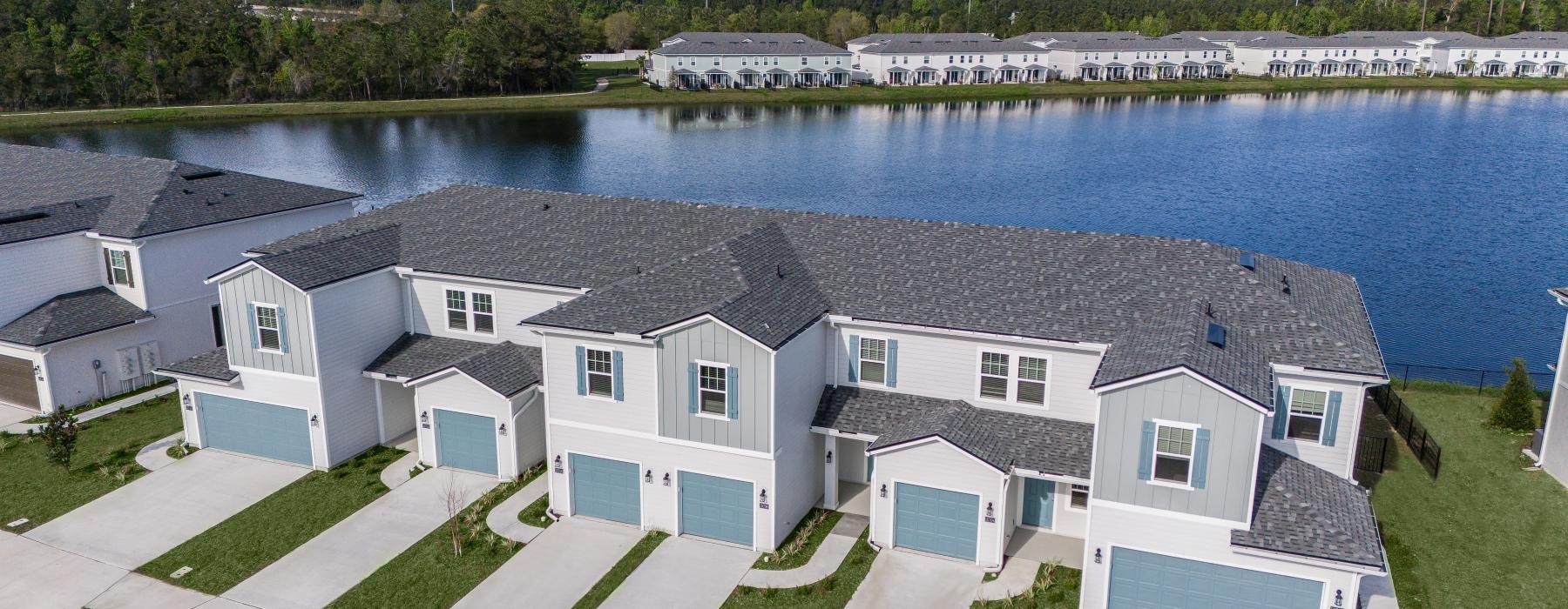 a row of houses next to a body of water